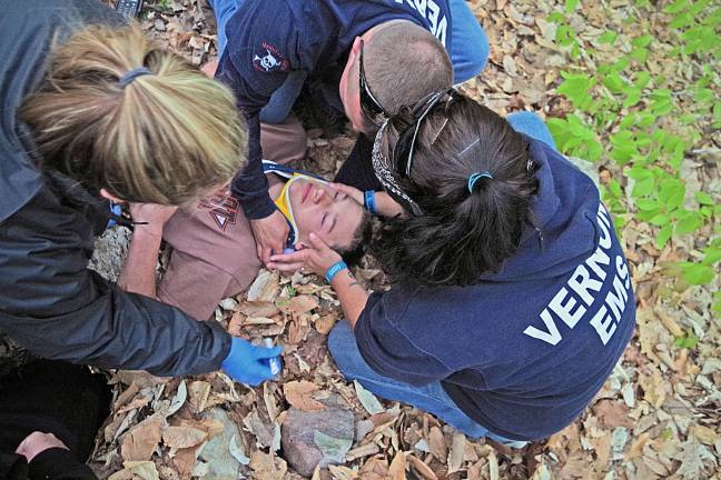 Vernon EMS personnel work with a simulated victim of a serious mountain biking accident.