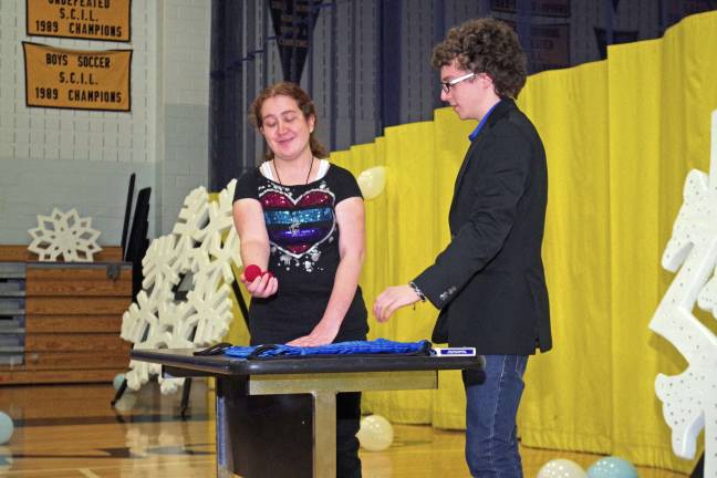 Magician Alex Block, 18, a senior from Pleasant Valley Lake performs a little magic with the help of student Melanie Marcano.