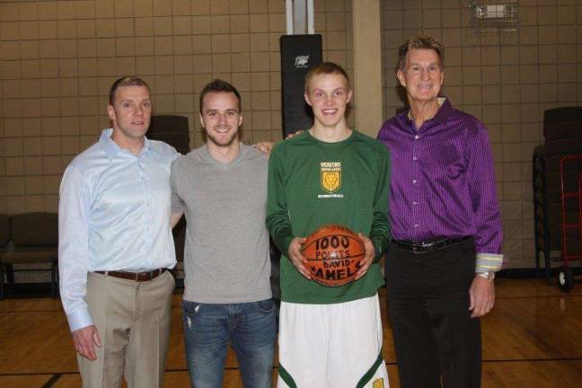 Photo provided David Amels fromVeritas Christian Academy scored his 1,000th point. Although David is thethird player in Veritas history to score 1,000 points, he is the first to do it as a junior. Pictured from left: Coach Timm Dillon, Isaac Delbury(Veritas's first 1,000 point scorer), David Amels and Coach Terry Tucker.
