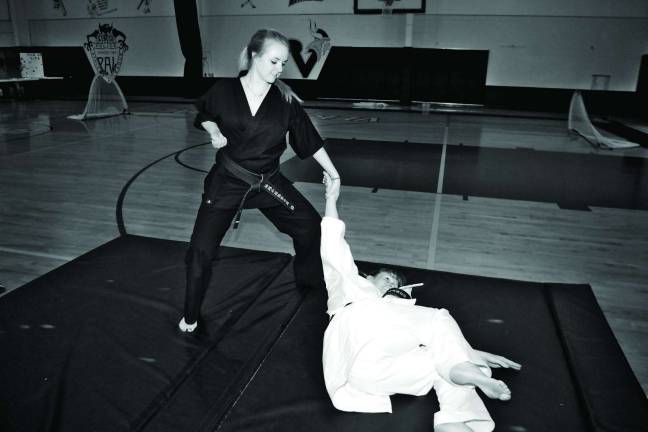 Vernon Valley Karate Academy student and black belt Deidra Lohwin, 17, throws fellow black belt Monica Rolando to the mat during a martial arts demonstration.