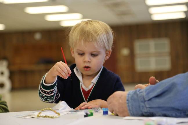 Michael Conover of Wantage was busy painting his ornaments at the party (2)