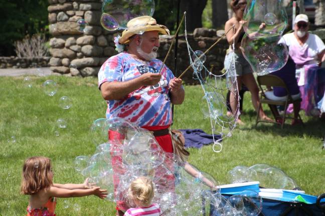 Photo by Gale Miko Kids play in bubbles at the Medicine Wheel event on May 30.