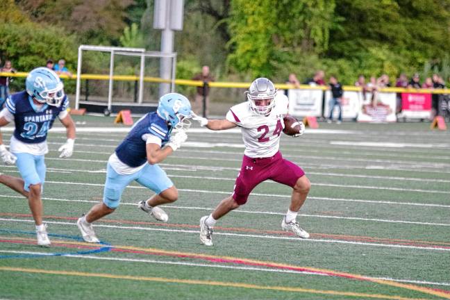 <b>Newton ball carrier Evan Cotter puts a stiff-arm on a Sparta defender. He made one touchdown, rushed for 91 yards and caught three passes for 137 yards.</b>