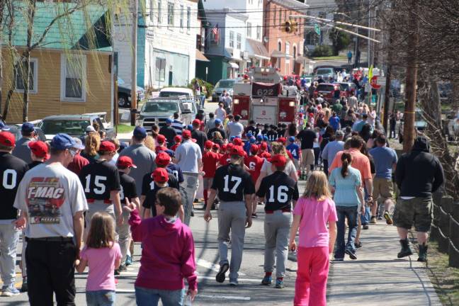 Members of Sussex Wantage Little League march during the opening day parade.