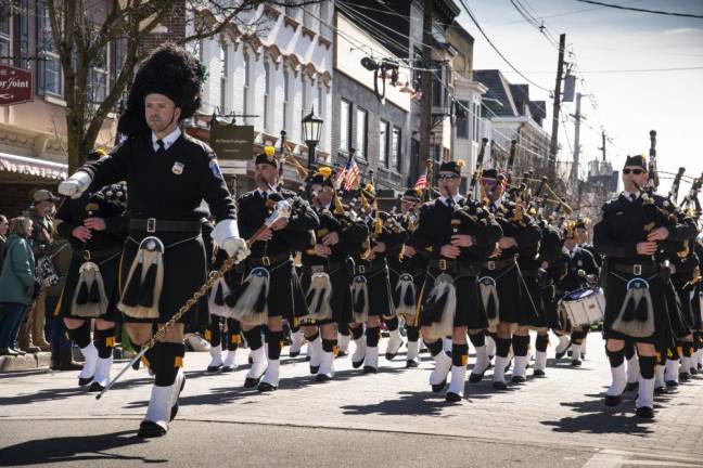 Members of the Police Pipes and Drums of Morris County march in the parade.