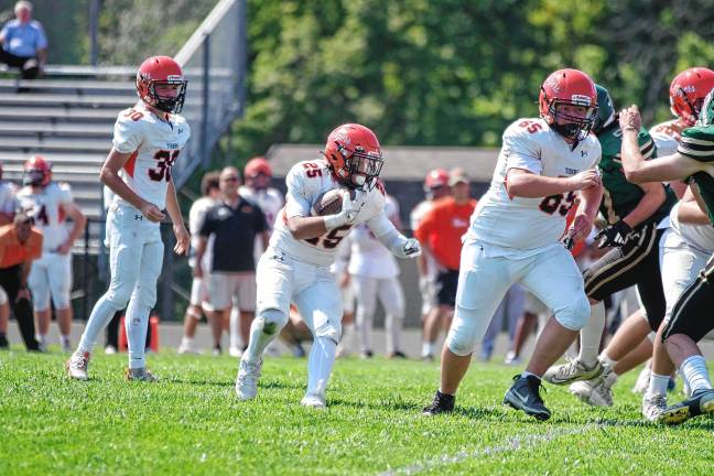 <b>Hackettstown ball carrier Anthony Best follows his blocker Zach Jenkins (65). Best scored one touchdown.</b>