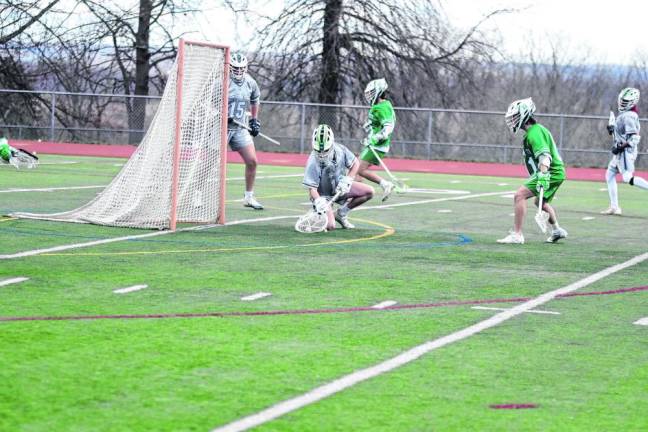 Sussex County's goalie Liam MacClugage stops the ball with his stick, preventing a goal.