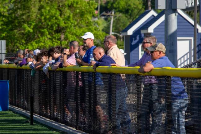 Parents and family members watch the Sparta and Vernon girls lacrosse teams from both sides of the fence.