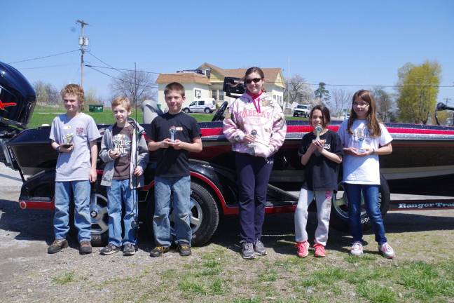 Fishing Derby winners in the third to sixth grade category were from left: Dylan Harris, Tyler Hammerstedt, Matt Bott, Lauren Mele, Megan Hertlein, and Kate Blackmore. The prizes did not include the speedboat and trailer in the background.