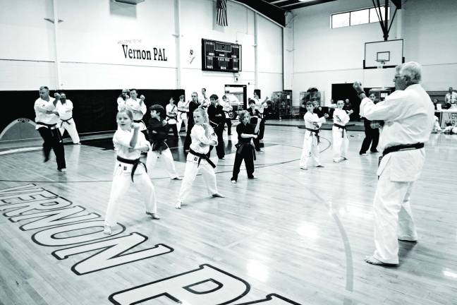 Sixth Degree Black Belt, Sensei Tom Shull, is shown leading students through a series "katas" or detailed choreographed forms that help the students develop the ability to use those techniques and movements in a natural, automatic, reflex-like manner. Shull's Vernon Valley Karate Academy is located on Theta Drive in Vernon and currently has nearly 200 students.