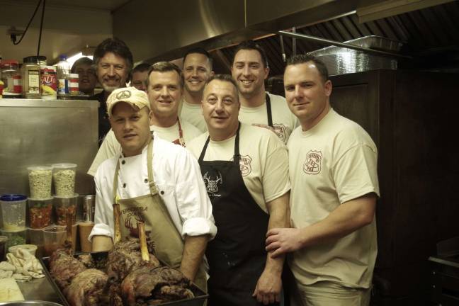 After three days of preparing a feast for nearly 150 hungry diners, members of the kitchen crew takes a break for a group shot. From the left are volunteer Tom Zabriskie, master game chef Denis Viera, Lt. Brian Jernick, Ptl. Dan Young, volunteer Larry Schwind, Ptl. Ken Kuzicki, and Det. Keith Curry.