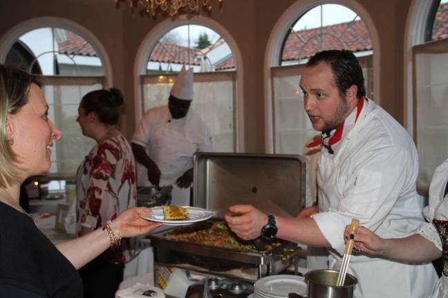 Hans Aichem of Black Forest Inn serving Jennifer Koza-Todaro of Frankford and The Chocolate Goat in Lafayette.