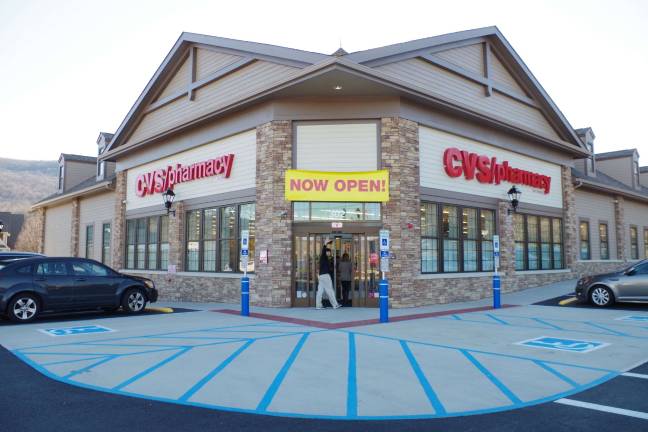 A customer waves as he enters the new CVS store on Route 94.