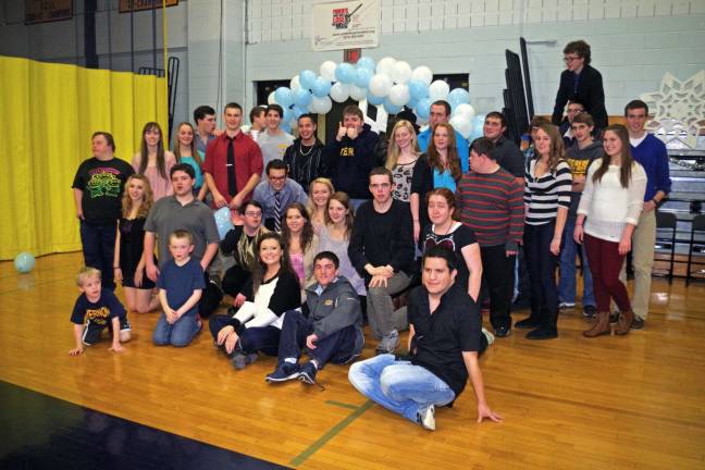 This group of DECA and special needs children pose in front of a freestanding, pale blue and white balloon arch creation that was the work of Ashley Weigel, 18, a senior from Highland Lakes.