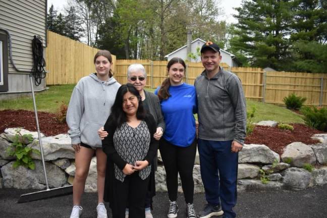 Volunteers Samantha Darmienmto, left, and Julia and Matt Hamann, right, pose with Evelyn Dudziec and her adopted daughter, Katie, front, at Katie’s House in Stillwater.