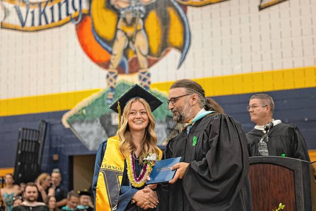 <b>Marissa Develez receives her diploma from Assistant Principal Nicholas Demsak.</b>