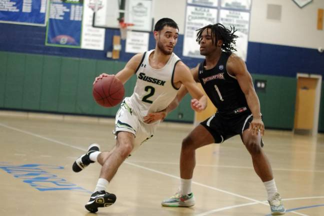 Jesus Romero of SCCC maneuvers the ball while covered by Northampton's Arkel Batts. He scored three points, grabbed eight rebounds and made two steals.