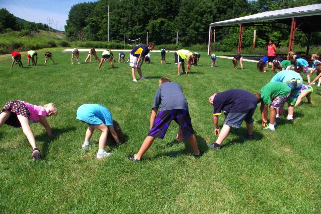 PHOTOS BY CHRIS WYMAN Burning off literally thousands of calories per hour is when 40 children together do calisthenics behind the Vernon PAL building.