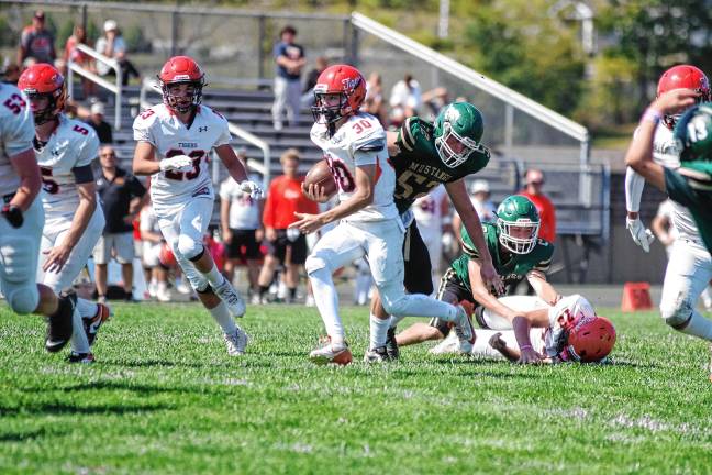 <b>Hackettstown ball carrier Carter Grant runs through an opening in the Sussex Tech defense.</b>