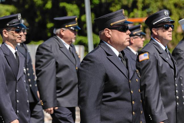 <b>Firefighters march in the parade.</b>