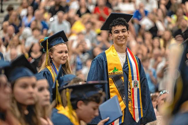 <b>Alex Fessel waits in line to accept his diploma.</b>