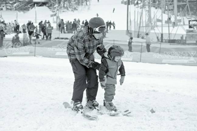 A youngster gets a hand with learning how to ski last weekend.