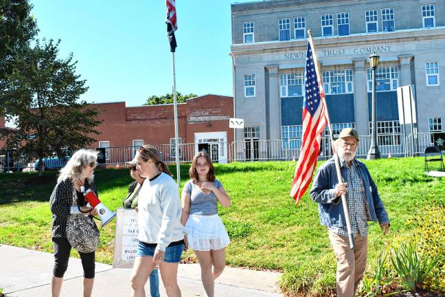 David DeWit of Hampton Township carries a flag.