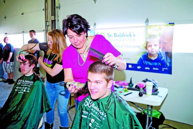Nicki Clemens of Roxbury's Nino's Expressions gives Chris Ross, 16, of Vernon a trim.