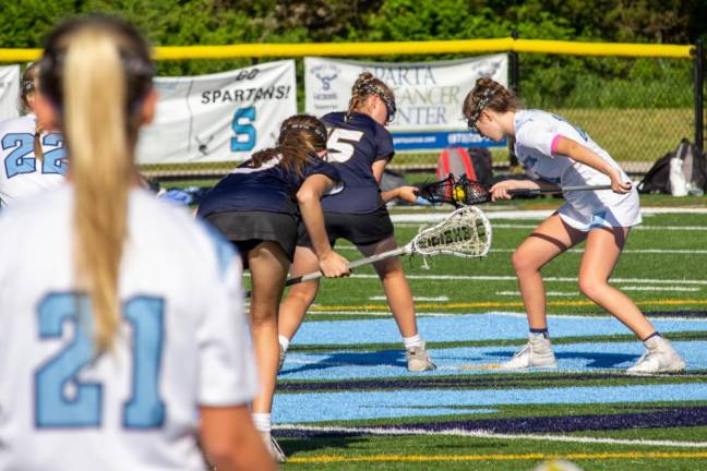 Catherine Siipola (22) and Jane Bleakley (21), both of Sparta, along with Grace Dobrzynski (13) of Vernon, wait for their teammates Sidney Tassel (15) of Vernon and Aine Byrne (14) of Sparta to draw the ball. A draw is used in girls lacrosse to start play after each goal.