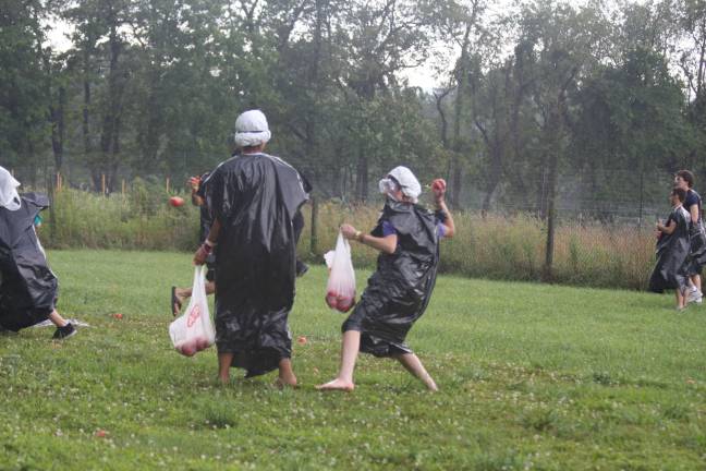 Scene from the rotten tomato fight on Saturday at Sunset View Farm. Trash bags helped fighters protect their clothing.