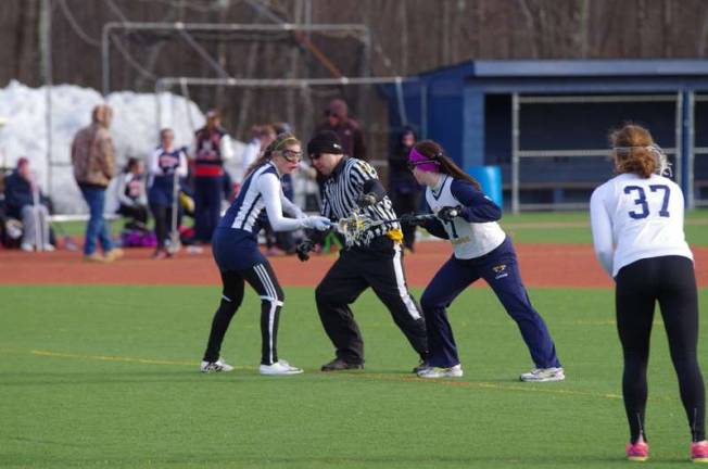 A referee sets junior varsity players for action. Pope John XXIII High School in Sparta, New Jersey hosted North Warren Regional High School for lacrosse scrimmages on Monday, March 24, 2014. The girls varsity and junior varsity teams participated.
