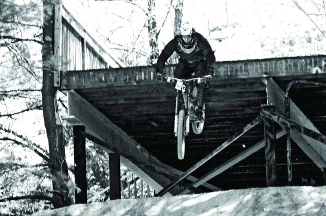 Riders flying off a jump near the Red Tail Lodge at Mountain Creek.
