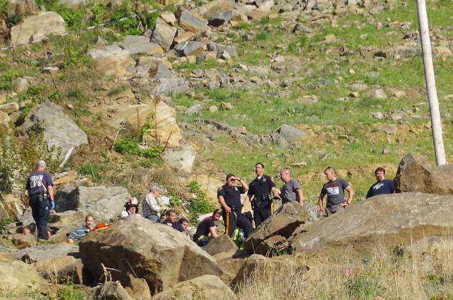 Police, firefighters, and EMT personnel at the crash site.