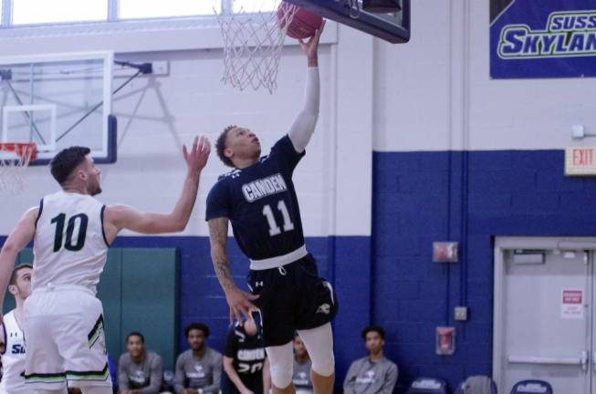 Camden County's Rahsaan Brown raises the ball towards the hoop during a shot in the first half.