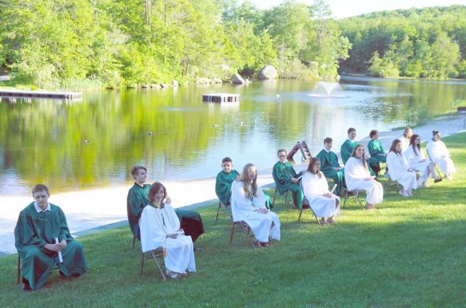 Graduates in front of Heater's Pond after the picture ceremony. (Photo by Vera Olinski)