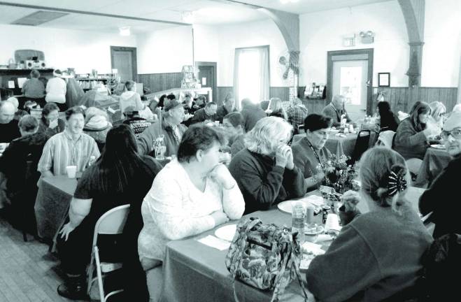 Photo by Viktoria-Leigh Wagner Attendees eat at the third annual Christmas Dinner held by the United Methodist Church.