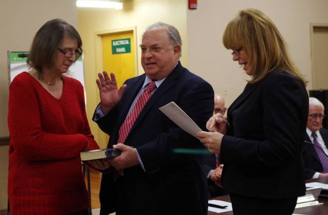 At center, Councilman Daniel Kadish is sworn in for another four-year term by Assemblywoman Gale Phoebus (right). At left, Kadish&#xfe;&#xc4;&#xf4;s wife Carol is shown holding the Bible. Mr. Kadish is also now the Council President.
