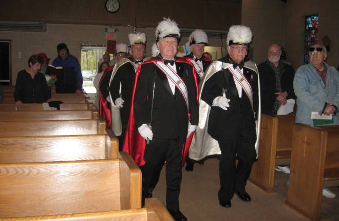 PHOTOS BY JANET REDYKE The Knights of Columbus lead the Rev. Ricardo Ortega, Our Lady of Fatima's pastor, into church for the 100th celebration of Fatima.