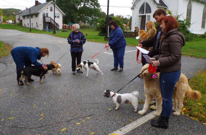 Dog owners and their pets wait to be blessed at the St. Thomas Episcopal Church Blessing of the Animals service.