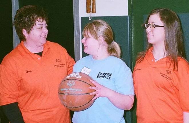 Taking a break between events at the Area 3 Special Olympics Basketball Skills Meet at the Alfred C. MacKinnon Middle School in Wharton are (from left) Sue Johnston, school counselor with the Wharton school district, who helped arrange for the venue, Special Olympics athlete Carol Spilatros of Vernon and Special Olympics volunteer Marissa Conroy of Mine Hill.