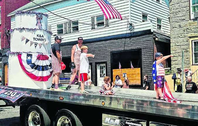 <b>K&amp;A Towing drives by on a flatbed.</b>