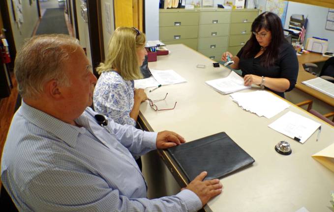 PHOTO BY CHRIS WYMAN Vernon Township Clerk Lauren Kirkman individually inspected and then hand-stamped the over four hundred petitions submitted by current councilman Dan Kadish and resident Sandy Ooms. Kadish was re-elected to another four-year term while Ooms was newly elected to the council. Harry Shortway was elected to replace Mayor Victor Marotta.