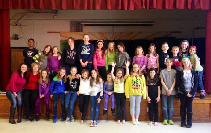 Justine Mahon (second from left, bottom row) poses with the kids and helpers who helped her bring back the school's talent show.