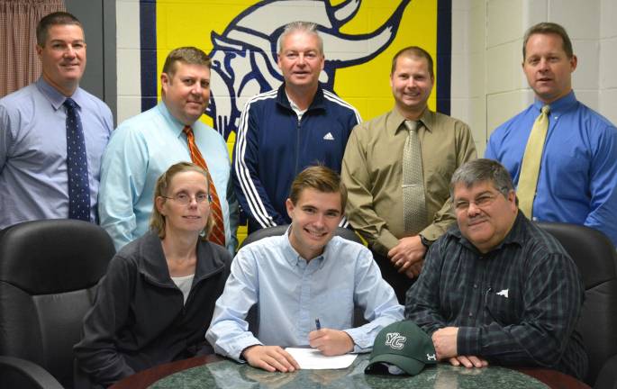 Seated with Bryan are his parents Mr. and Mrs. Forino, Standing left to right: Athletic Director Bill Foley, Track Coaches Jim Saganiec and Matt Ferguson, Cross Country Coach Jim Shenise and Principal Drew Krause.