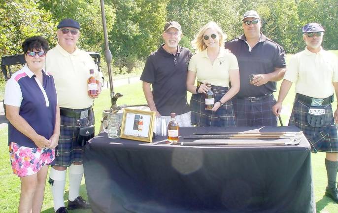 Golfers Buffy Whiting, Doc &amp; David Davidson enjoy a GlenLivet Scotch tasting station hosted by Crystal Springs Katie, John &amp; Joe