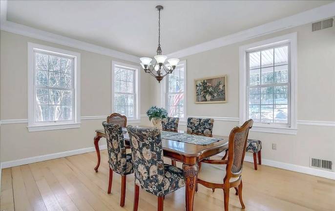 Upscale streamfront custom farmhouse offers space and more