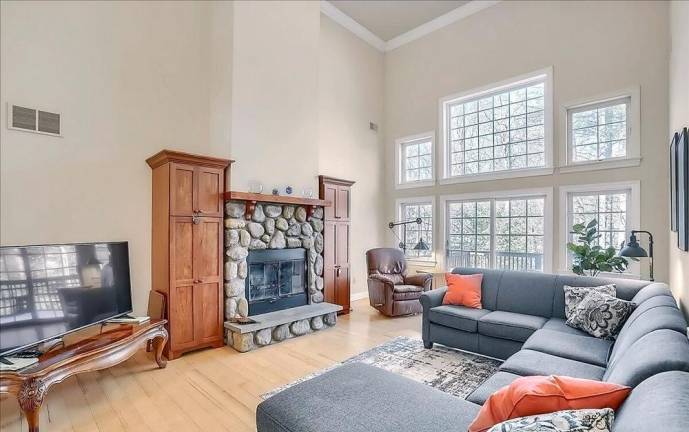 Upscale streamfront custom farmhouse offers space and more
