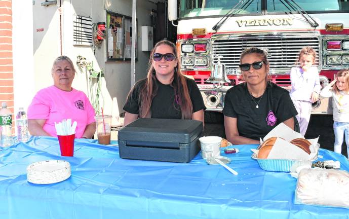 <b>Paula Gay, Caitlin Taylor and Kristi Baldwin of the Auxiliary sit at a table.</b>