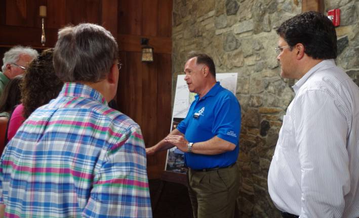 At center, David Koffman is shown explaining plans for a new spa.