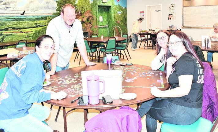 <b>Christine and Josh Devonte of Vernon, Rhiannon Gutjar of Vernon and Adriana Minassian of Vernon pose while working on puzzles.</b>